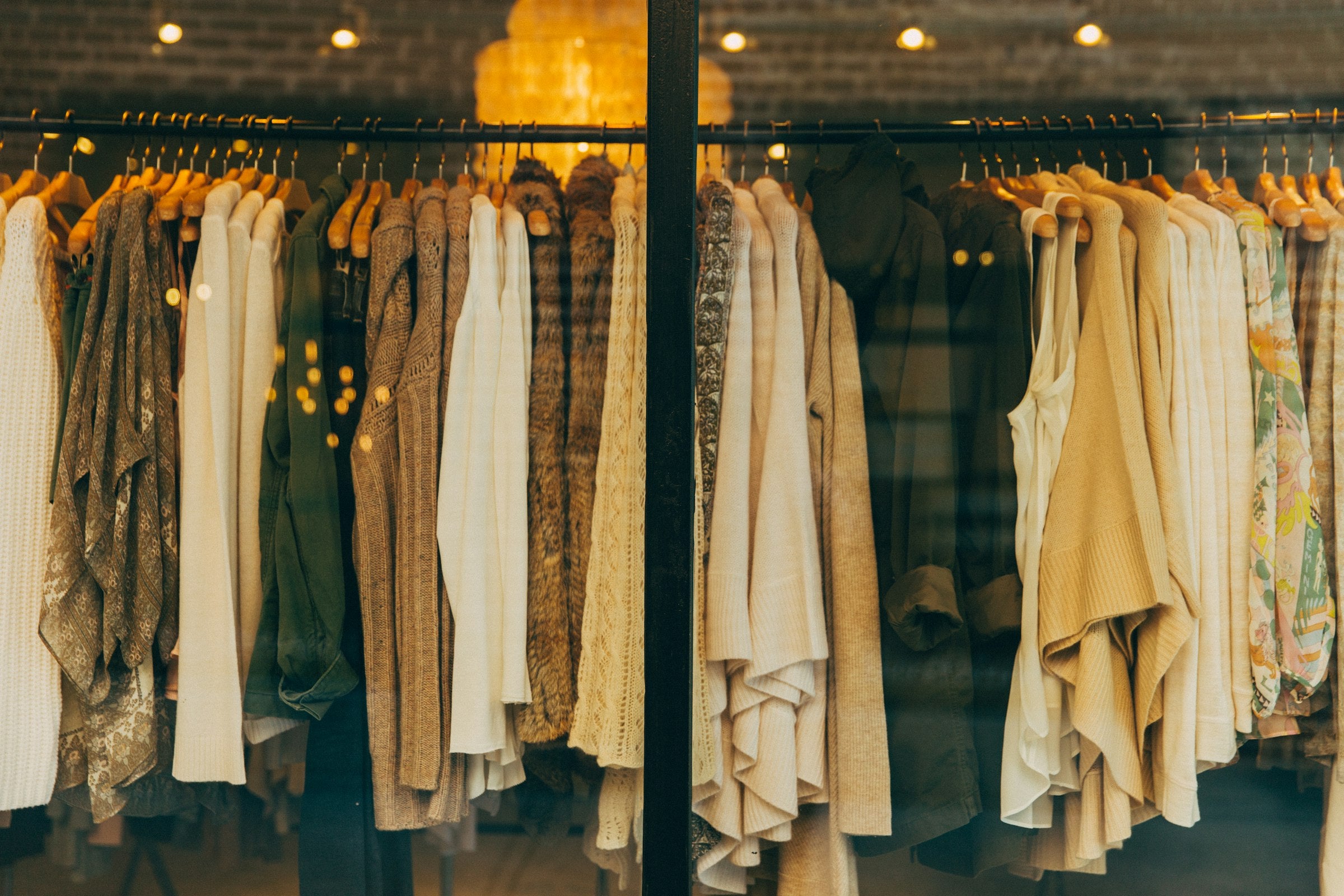 Elegant boutique clothing on a rack in warm light